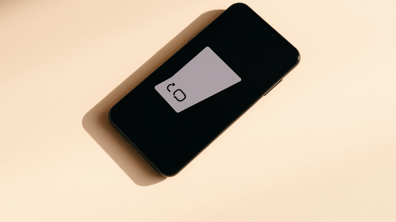 A phone showing a shareable WeLoyal referral card on a cream background.