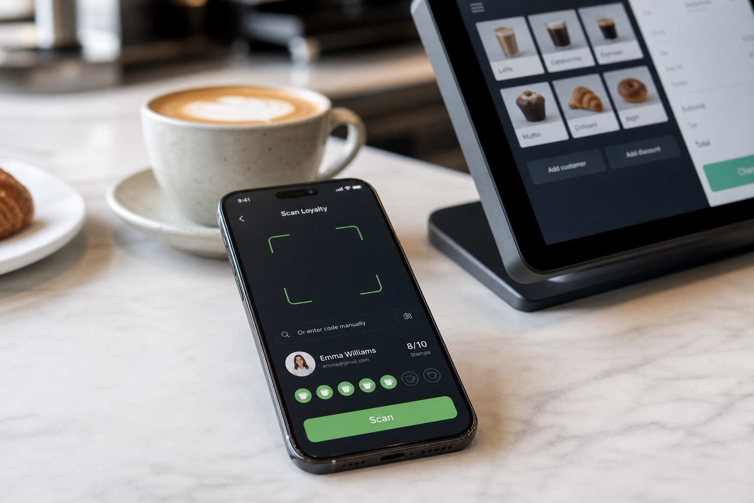 A smartphone on a café counter showing the WeLoyal Scanner App beside a POS tablet and coffee cup.